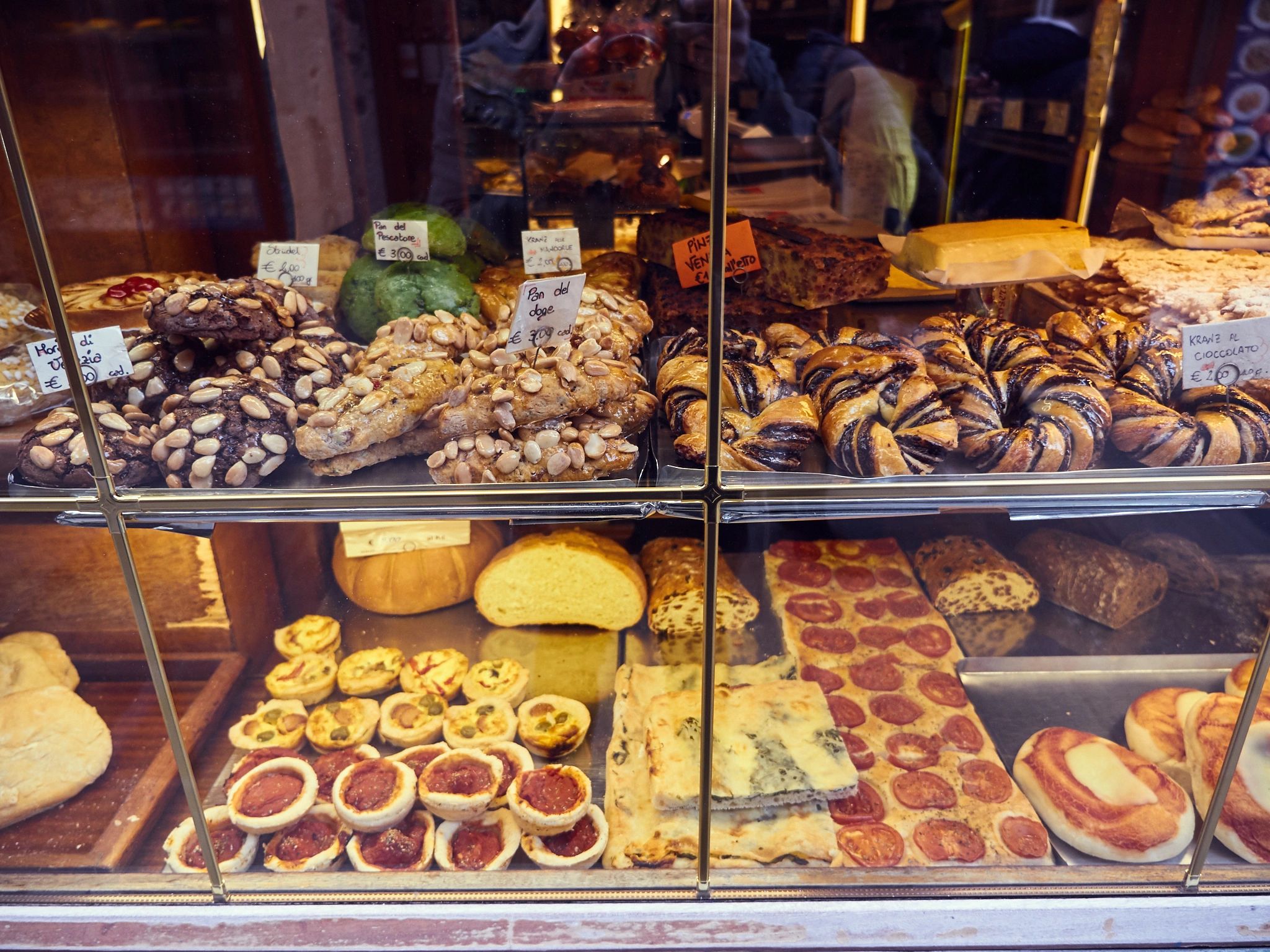 Fresh croissants and pastries in a bakery display case